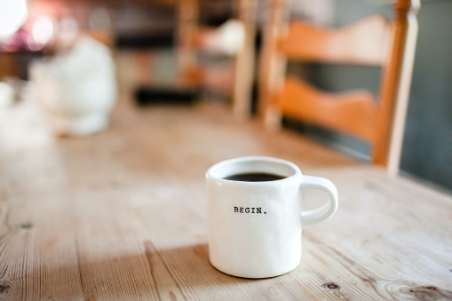 Cup of tea with Begin written on the side