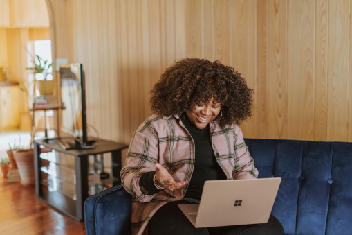 Someone on a laptop and happy